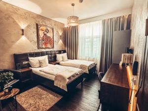 Posteľ alebo postele v izbe v ubytovaní Alfons Boutique Hotel