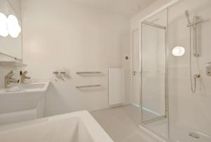 a white bathroom with a shower and a sink at 2 chambres WC séparés in Saint-Germain-du-Crioult