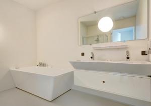 a white bathroom with a sink and a mirror at 2 chambres WC séparés in Saint-Germain-du-Crioult