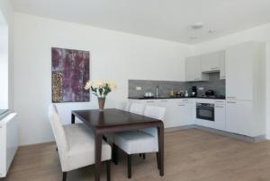 a kitchen with a wooden table and white cabinets at 2 chambres WC séparés in Saint-Germain-du-Crioult
