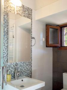 a bathroom with a sink and a mirror at Beautiful house with garden and amazing lake view in Kastoria