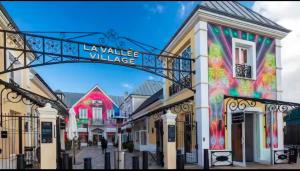 a sign for la walle village on a street at Maison le B - Disneyland Paris - Parking - Wifi in Bussy-Saint-Georges