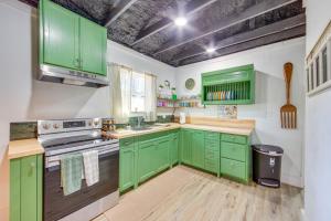 a green kitchen with wooden floors and green cabinets at Winnsboro Home on 17 Acres Outdoor Spots and Trails in Winnsboro