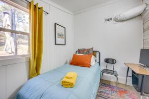 a bedroom with a bed with a yellow blanket on it at Winnsboro Home on 17 Acres Outdoor Spots and Trails in Winnsboro