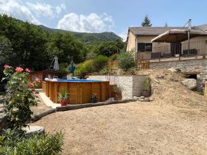 a backyard with a swimming pool and a house at Villa en pleine nature avec piscine in Sablières