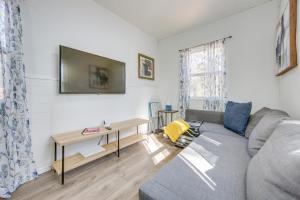 una sala de estar con un sofá y una mesa en Winnsboro Tiny House with Trails, Yard Games and More!, en Winnsboro
