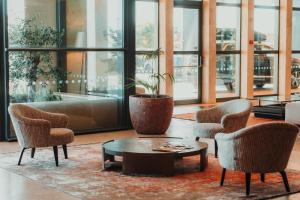 a living room with two chairs and a coffee table at Real Marina Hotel & Spa in Olhão