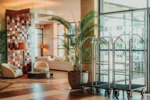 a living room with a potted plant and a couch at Real Marina Hotel & Spa in Olhão