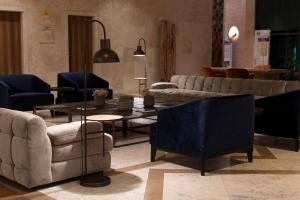 a living room with couches and chairs and tables at Real Marina Hotel & Spa in Olhão