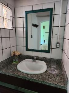 a bathroom with a sink and a mirror at Pousada São Francisco in Cumuruxatiba +49 photos