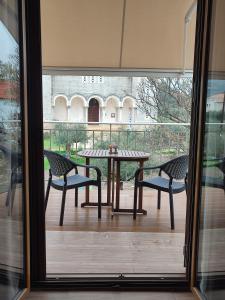 a patio with a table and two chairs on a balcony at Cosy studio 1 in Stoupa in Stoupa
