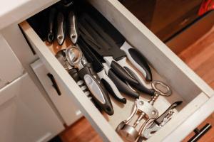 a drawer with scissors and other tools in it at Sojourn at Colley Manor Unit 3 in Norfolk +22 photos