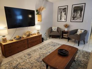 a living room with a large flat screen tv on the wall at 3BR Oasis with Pool in Cocoa in Cocoa