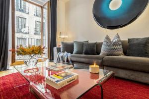 a living room with a couch and a table at Gran Via by SkyKey in Madrid +35 photos