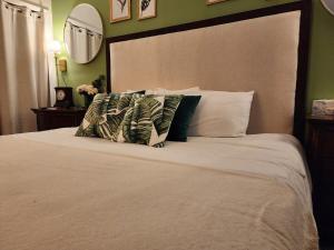 a bedroom with a large white bed with pillows at 3BR Oasis with Pool in Cocoa in Cocoa