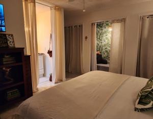 a bedroom with a bed and a sliding glass door at 3BR Oasis with Pool in Cocoa in Cocoa