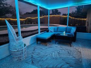 a patio with a couch and a table and chairs at 3BR Oasis with Pool in Cocoa in Cocoa