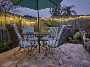 a table and chairs with an umbrella on a patio at 3BR Oasis with Pool in Cocoa in Cocoa