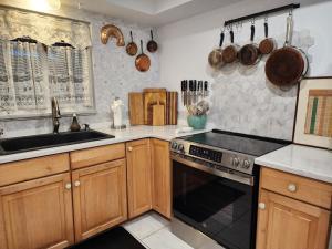 a kitchen with a sink and a stove top oven at 3BR Oasis with Pool in Cocoa in Cocoa