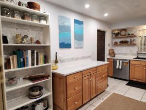 a kitchen with a counter and shelves with books at 3BR Oasis with Pool in Cocoa in Cocoa