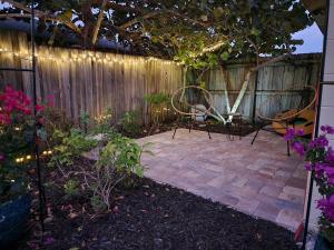a patio with two chairs and a fence at 3BR Oasis with Pool in Cocoa in Cocoa