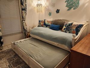 a bed sitting in a room with a table at 3BR Oasis with Pool in Cocoa in Cocoa