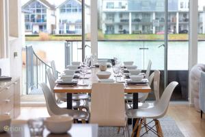 a dining room with a long table and chairs at Howells Mere 26, Swans Down - P in Somerford Keynes