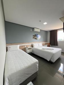 two beds in a hotel room with two beds sidx sidx sidx at RUBBO HOTEL in São Valentim +36 photos