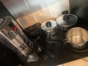 a kitchen with two pots and a blender on a counter at Flat Aconchegante in Goiânia