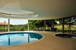 a swimming pool in the middle of a house at Hotel Fasano Boa Vista in Pôrto Feliz