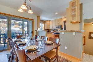 a dining room with a table and a kitchen at Airy Winter Park Gem with Private Outdoor Hot Tub! in Winter Park