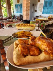 a table with two plates of food on it at Pousada São Francisco in Cumuruxatiba