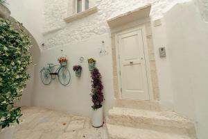 a door with a bike on the side of a building at Suite Dimora Antico Campanile in Locorotondo