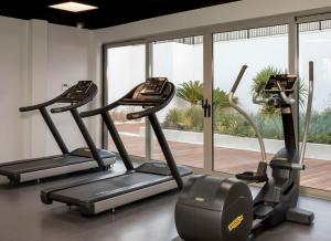 a gym with three tread machines and a window at Radisson Collection Hotel, Bodrum in Akyarlar