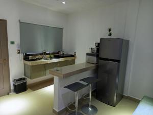 a kitchen with a sink and a refrigerator at Mi habitat holbox-Maravilla natural in Holbox Island
