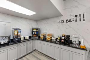 a kitchen with a counter top with a coffee shop at SureStay By Best Western Phoenix Airport in Phoenix