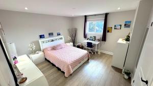 a bedroom with a bed and a desk and a window at Luxury Modern Retreat, Sauna, Theatre, Pool Table in Mississauga
