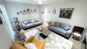 a living room with two couches and a table at Luxury Modern Retreat, Sauna, Theatre, Pool Table in Mississauga