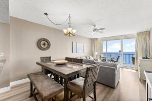 a living room with a table and chairs and a couch at Majestic Beach Resort 1404 in Panama City Beach