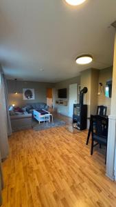a living room with a hard wood floor and a couch at Apartment Vestpollen in Vestpollen +9 photos
