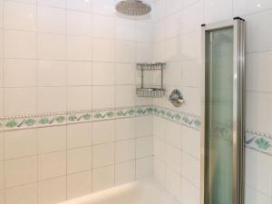 a shower with a glass door in a bathroom at Footdee Cottage in Aberdeen +39 photos
