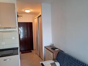 a living room with a couch and a kitchen at Apartman 98, free parking in Karlobag