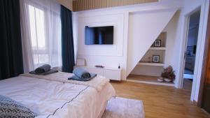 una camera con letto e TV a parete di Relax sauna apartman a Divčibare