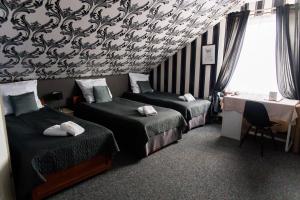 Posteľ alebo postele v izbe v ubytovaní Hotel Napoleon