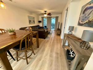 a living room with a table and a couch at 2Br 2Ba Condo on Golf Course in Pawleys Island