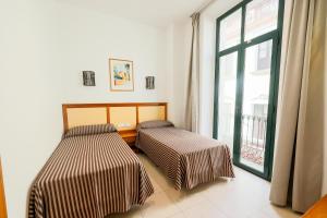Кровать или кровати в номере Apartamentos Royal