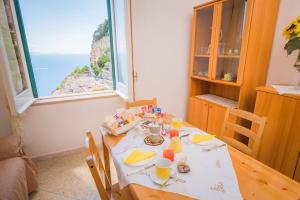 a dining room with a table with a view of the ocean at Casa Adele Pogerola in Amalfi