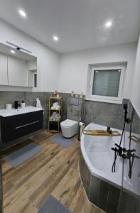a bathroom with a tub and a sink and a toilet at Ferienwohnung in Bad Laasphe +11 photos