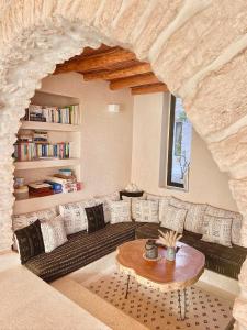 a living room with a couch and a table at Kaouki Lodge in Sidi Kaouki