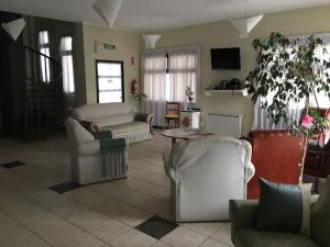 a living room with couches and a table at Hotel CALAS in General San MartÃ­n